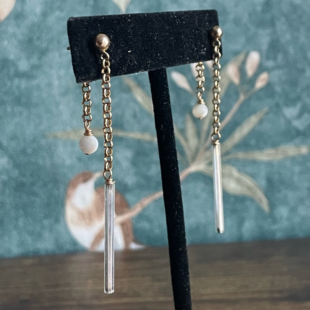 Modern double-sided drop earrings in a gold finish. Never worn.